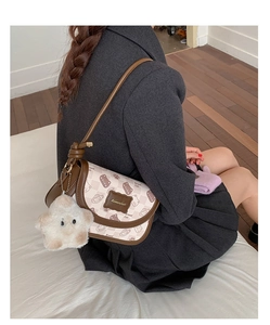 Detail showing Bread Cat crossbody bag with plush star charm and premium leather trim