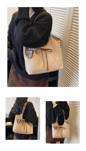 Detailed view of khaki suede tote bag with brown leather trim and bow knot decor