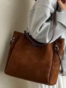Fashionable large brown suede tote bag for women with elegant golden metal rings