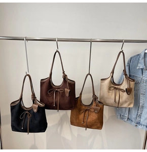 Detail of vintage matte tote bags in four colors with decorative bow and long straps