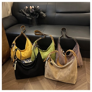 Selection of large vintage suede hobo bags in five colors with wood bead tassels