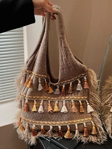 Brown bohemian knit tote bag with colorful tassels and fringe detail for women