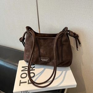 Detail view of the vintage coffee brown suede half-moon shoulder bag with silver hardware