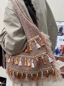 Ethnic bohemian hobo bag with long tassels and woven texture for autumn style