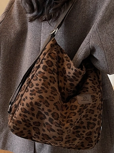 Detailed close-up of leopard print Hobo bag with adjustable strap and side brand label