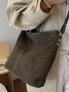 Retro olive green suede tote bag with leather trim and silver rivets in minimalist style