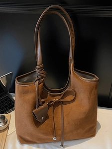 Retro brown suede tote bag with drawstring bow and metal charms for women