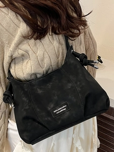 French retro black crossbody bag with marble texture and knot strap shown on a model