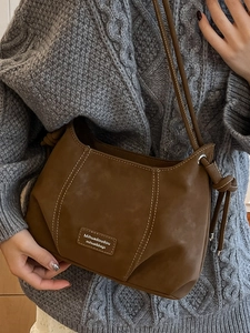 French vintage brown crossbody bag with white stitching and textured strap detail