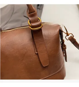 Detail of vintage brown bag showing antique gold ring hardware and fine stitching