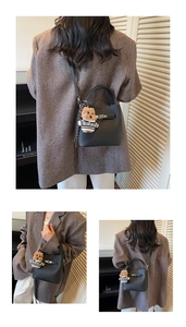 Detail of black lychee leather bucket bag with silver twist lock and cute bear charm