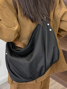 Retro black canvas tote bag with brown leather strap and silver rivet details