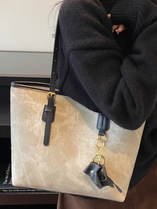 Large tote bag with grey marble texture and elephant charm shown in a lifestyle scene