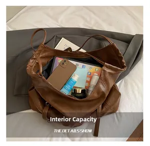 Top-down view of a spacious brown faux leather tote bag showing items inside