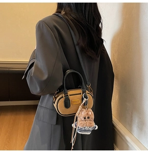 Borsa Boston in pelle opaca marrone con ciondolo a orsetto e manico nero elegante