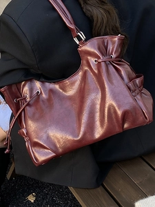 Vintage burgundy faux leather shoulder bag with drawstring detail and silver hardware