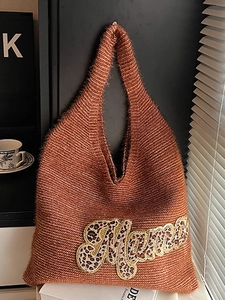 Brown knit tote bag with leopard Mama patch shown in a cozy indoor afternoon tea setting