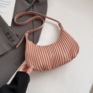 Detailed view of the pink pleated texture and craftsmanship on this trendy hobo bag