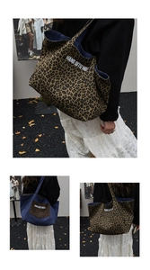 Detail of large reversible tote bag featuring leopard print and denim canvas with HQTU text