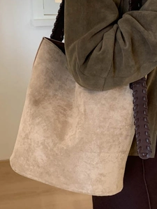 Sac seau minimaliste en daim beige avec bandoulière tissée pour le style automnal