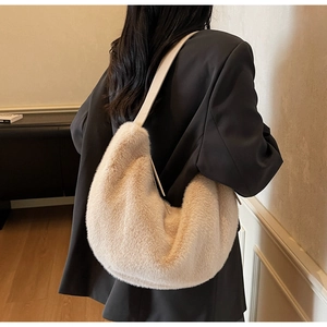 Plush beige hobo bag detail showing soft faux fur texture and matching leather strap