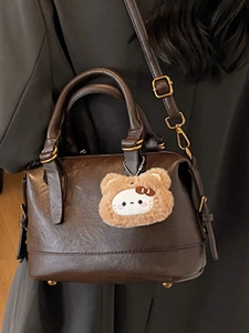 Retro brown leather-style doctor handbag with a cute plush bear charm for women
