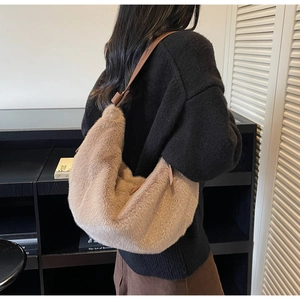 Close-up of fluffy khaki faux fur hobo bag with adjustable leather shoulder strap