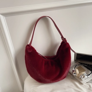 Detail of burgundy faux fur hobo bag showing plush texture and matte leather strap