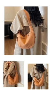 Detail view of the orange canvas crossbody bag showing the adjustable silver metal buckle