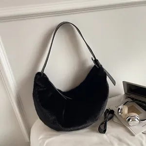 Detail shot of black plush faux fur hobo bag with adjustable leather shoulder strap