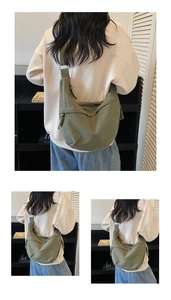 Detail of army green canvas crossbody bag showing durable fabric and minimalist dumpling shape