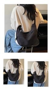 Detail view of black canvas crescent bag showing high-density fabric and adjustable strap