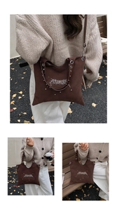 Detail of brown suede punk tote bag with silver studs and metal eyelet decorations