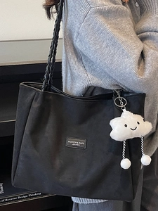 Minimalist black woven tote bag for women featuring a cute white cloud plush pendant