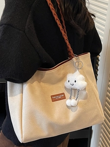 Large beige suede tote bag with brown woven shoulder strap and cute cloud charm detail