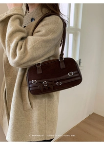 Detail of vintage coffee brown suede bowling bag with silver buckle and bow knot design