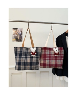 Close-up of vintage plaid woven canvas tote bags with cute plush bunny charms