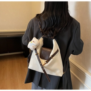 Rear view of a model wearing the Korean-style white and brown leather shoulder bag