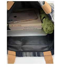 Interior view of large plaid tote bag showing capacity for laptop and daily essentials