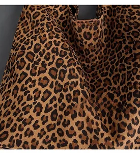 Close-up of the plush leopard print fabric and opening structure of this trendy tote bag