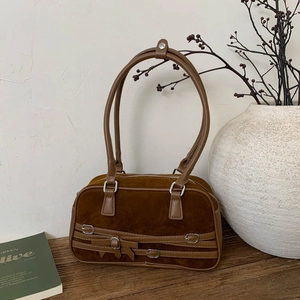 Retro caramel brown bowling bag in suede with decorative leather straps and silver buckles