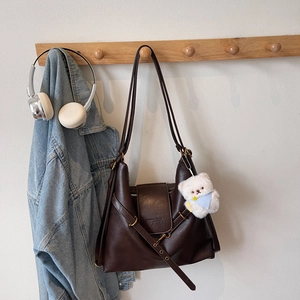Deep brown retro large capacity tote bag with white plush bear pendant on wooden hook