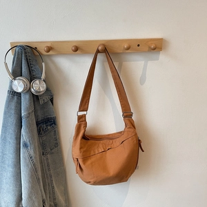 Caramel canvas crescent bag detail with adjustable strap and vintage silver hardware