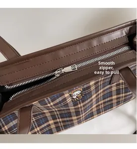 Close-up of smooth metal zipper and plaid fabric on the vintage tote bag