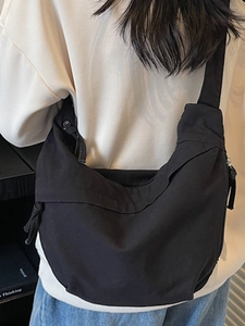 Japanese minimalist black canvas crossbody bag with pleated moon shape and drawstrings