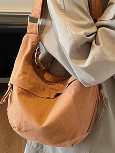 Minimalist large capacity canvas crossbody bag in orange brown with adjustable strap