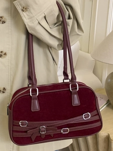 Minimalist burgundy suede bowling bag with vintage crossover straps and silver metal buckles