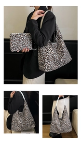 Close-up of leopard print tote bag and matching pouch set with white shoulder straps