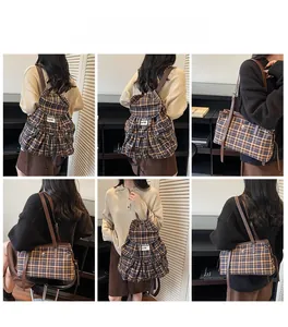 Detail view of retro plaid backpack with adjustable leather straps and drawstring closure