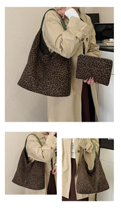 Detail of leopard print tote bag with dark green straps and matching inner pouch set